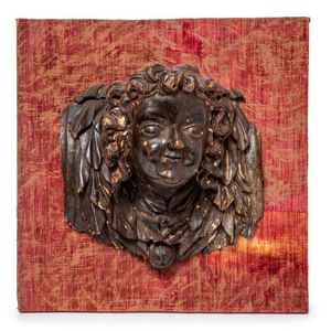 A pair of powerfully and expressively carved wood heads of…