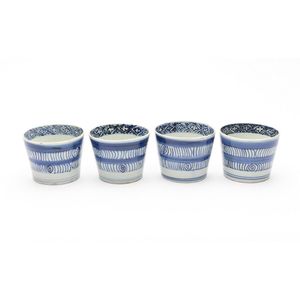A set of four Japanese blue and white barrel decorated cups.…