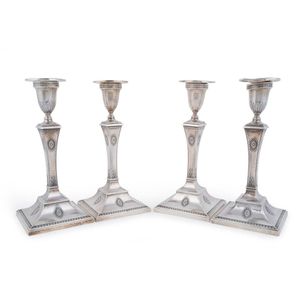 Four English sterling silver candlesticks by Goldsmiths &…