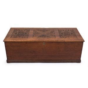 An antique English oak blanket box with carved top, 19th…