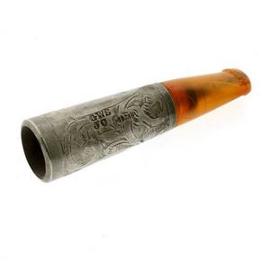 A hallmarked sterling silver cigar holder, with an amber…