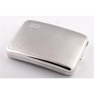 A sterling silver engine-turned cigarette case made for Prouds…