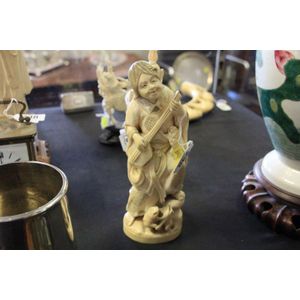 An ivory figure modelled of a lady with Mandolin and frogs.…