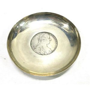 A sterling silver circular dish inset with an English coin,…