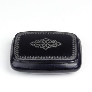 A Georgian papier mache snuff box, cushion shape with cut metal…