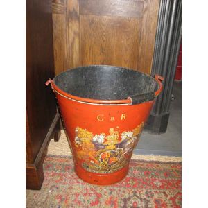 A large red painted tole ware coal bucket with central family…