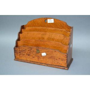 An Edwardian English oak desk tidy with brass patent button,…