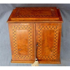 A desk compendium with two inlaid doors concealing four drawers,…