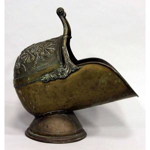 A Victorian brass coal scuttle with floral repousse design and…