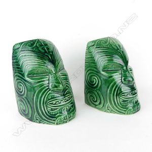 A pair of Crown Lynn Wharetana ware 'Moko' bookends, recorded…