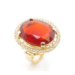 A large fire opal and 18ct yellow gold ring with a halo of…