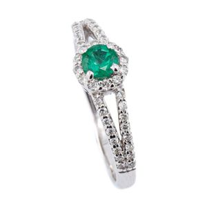 A 10ct white gold emerald and diamond ring, centring an approx.…