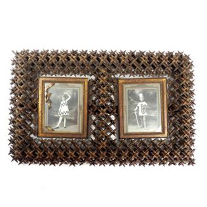 An antique 'tramp art' carved picture frame, the double frame…