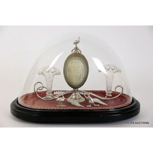 An emu egg and silver-plated epergne beneath a glass dome, 19th…