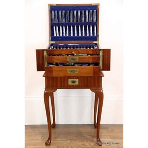 A mahogany cutlery canteen on stand with a silver plated King's…