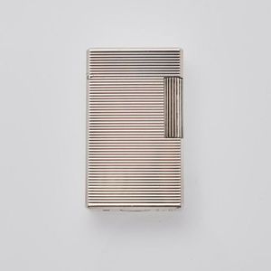 An S.T. Dupont silver tone scroll lighter with horizontal…