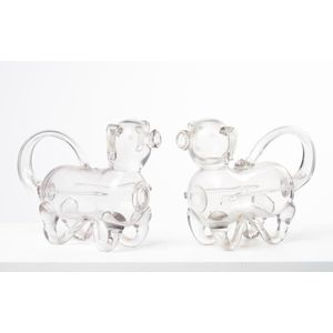 A pair of glass decanters in the form of dogs, possibly English,…