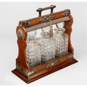 An oak silver plate mounted tantalus, English, circa 1900 with…
