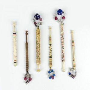 Six Victorian bobbins, five decorated bone and one wood.