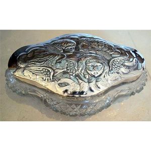 A sterling silver lidded crystal dressing table box