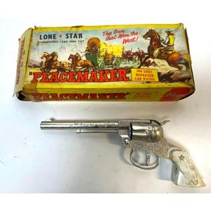 A lone star the Peacemaker 100 shot repeater cap pistol, c.1950,…
