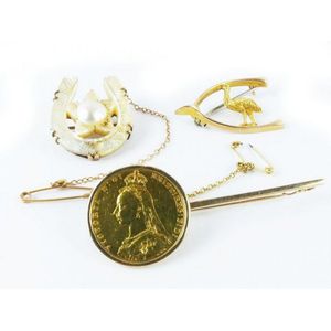 Three late 19th century brooches a carved mother of pearl star…