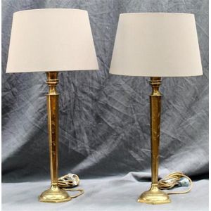 A pair of tall incised brass sub Continental bedside lamps…