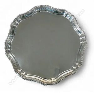 A mid-century sterling silver salver, pie crust rim, raised on…