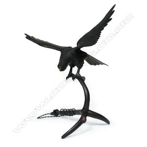 An early 20th century bronze hawk alighting upon anchor, wings…