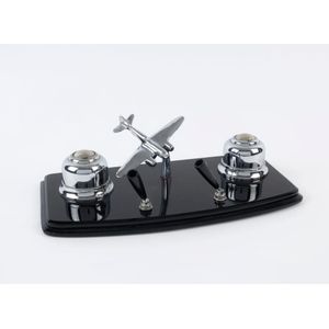 An Art Deco desk set, chrome aeroplane and inkwells on black…