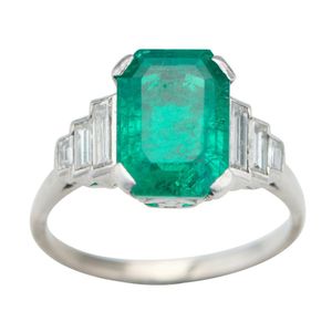 An 18ct white gold emerald and diamond ring, centring an…