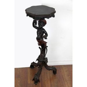 A 19th century walnut blackamoor torchere, the support of an…