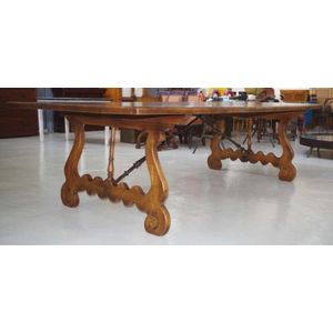 Large French farmhouse table with scrolled ends supported by…