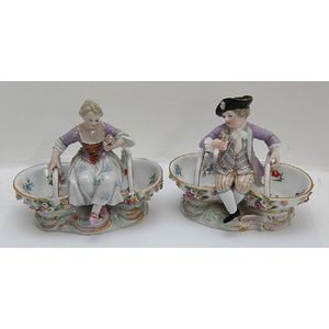 A pair of Meissen figured sweet meat baskets. 13 cm high.