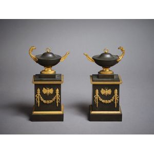 A pair of ornaments, depicting urns with eagle decoration, atop…
