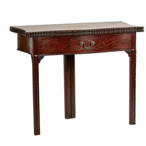 A George III Plum-Pudding mahogany tea table, the serpentine…