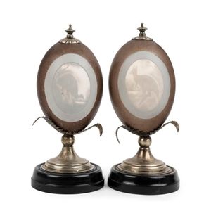 A pair of carved emu egg mantel ornaments, mounted in silver…