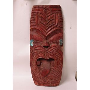 An early 20th century Maori carved large mask, distressed red…