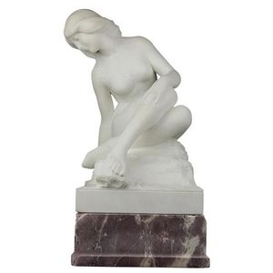 Alabaster carved figure of a nude bather on a red marble base.…