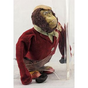 A tin plate litho & plush wind up Gorilla, in a suit, made in…
