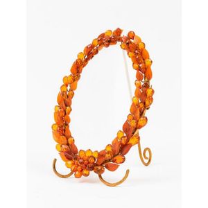 A faceted amber bead and leaf decorated gilt bronze picture…