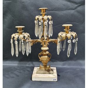 An early 19th century French candelabrum, with crystal drops.…