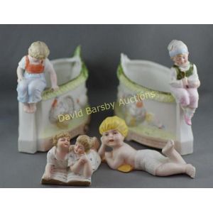 Two German bisque piano dolls, together with a pair of vases…