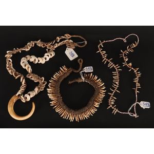 Three Sepik River necklaces, in boars tusk, dogs teeth, talons…