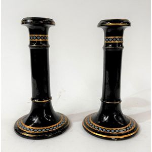 A pair of painted terracotta candlesticks with blue & gilt…