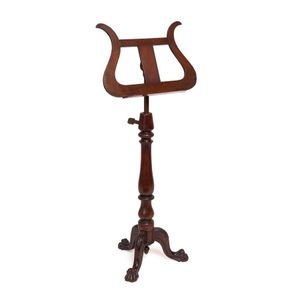 A rare Australian cedar music stand with carved lion paw feet…