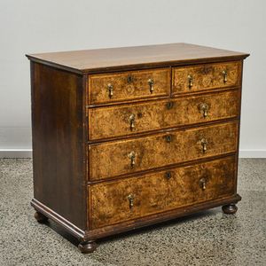 AN EARLY 18TH CENTURY HERRINGBONE-BANDED FIGURED WALNUT CHEST ON