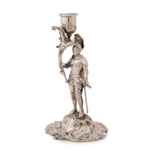 A Victorian sterling silver candlestick in the form of a knight,…