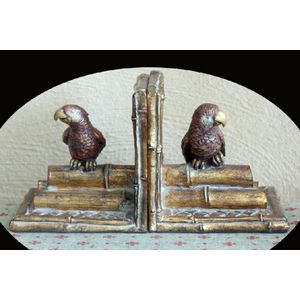 A pair of Venetian bookends, each with carved parrot on logs.…