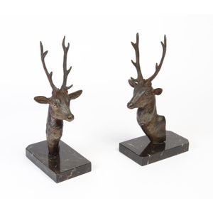A pair of spelter bookends in the form of stags heads on marble…